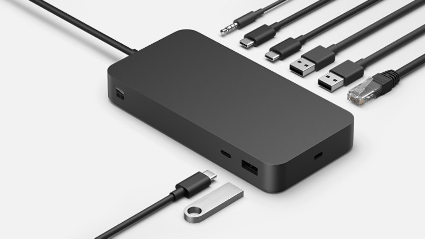 The various ports of a Surface Thunderbolt 4 Dock for Business surrounded by various connective cables.