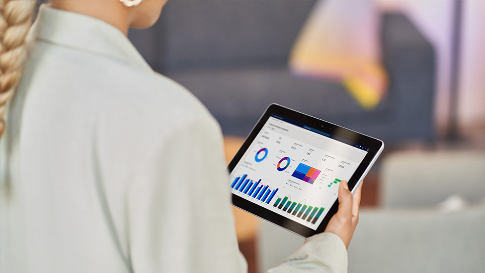 A woman looking a Dynamics on a tablet 