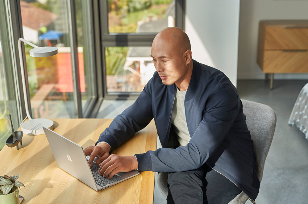 Une personne assise à un bureau utilise un Surface Laptop Go 2 pour les entreprises.