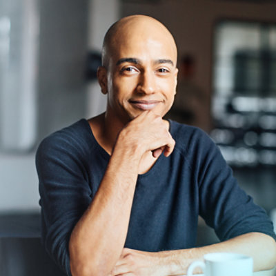 Hands holding a tablet displaying data in charts and graphs in Dynamics 365