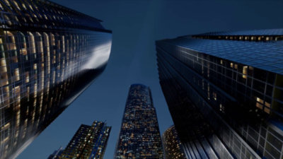 A low-angle view of tall buildings against a blue sky.