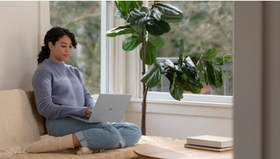 A woman working on surface laptop
