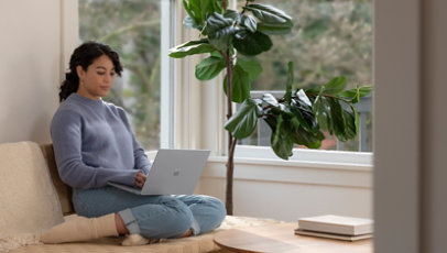A woman working on surface laptop
