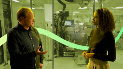 Two people having a conversation in a laboratory.