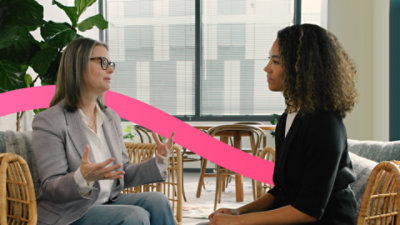 Two people sitting facing each other, having a conversation.