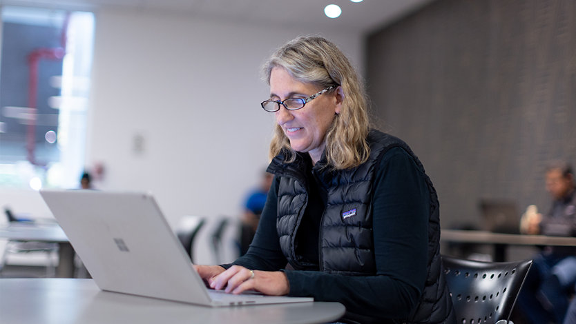 Kim Akers settles into a corner table at a coffee shop.