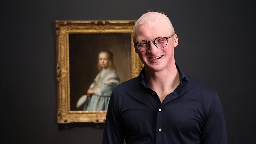 An art enthusiast with low vision, who participated in the Copilot description project, visits the Rijksmuseum in Amsterdam.
