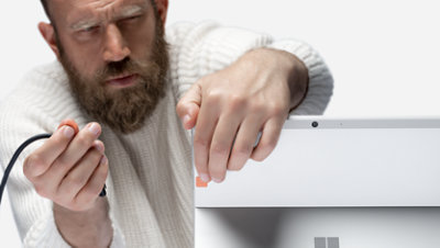 A person using Surface Adaptive Kit port tags.