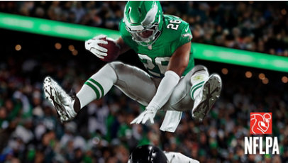 Saquon Barkley, Philadelphia Eagles Running Back, hurdles over a defender.