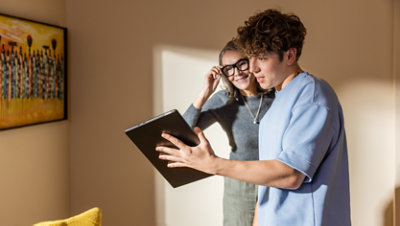 A mother and son look at a Surface Pro.