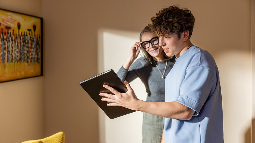 A mother and son look at a Surface Pro.