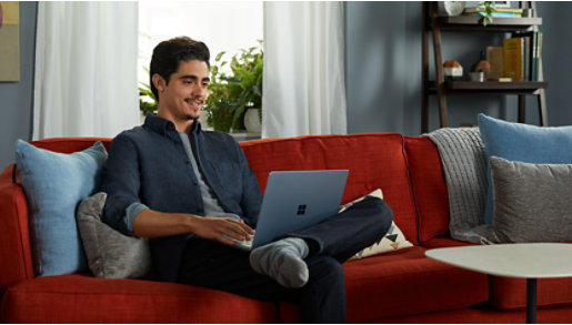 Parents helping a young student with homework on a laptop.
