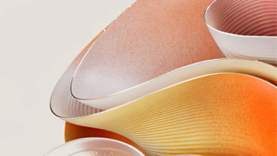 Abstract illustration of flowing ribbons in pinks and oranges.