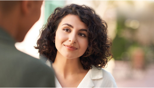 A woman listens to her co-worker.