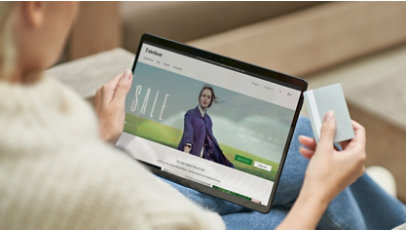 A person using a tablet for online shopping.