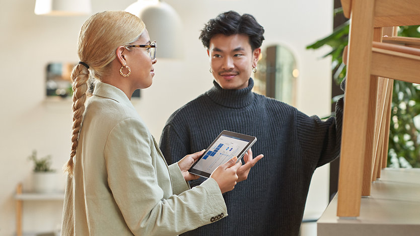 Woman with tablet speaking with a customer 