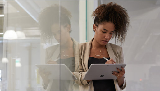 A person in a warehouse using a Surface Pro 7 and Surface pen.  