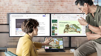 A man and woman collaborating on a laptop-mode Surface Pro 10 Platinum device with two monitors and an Arc Mouse.
