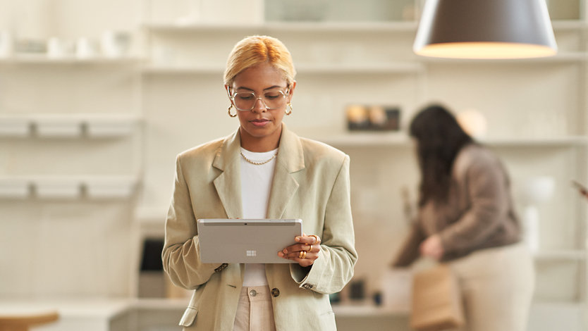 A businesswoman uses a Surface Pro tablet.