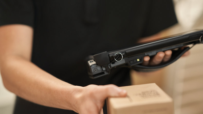 A person with a tablet and package.