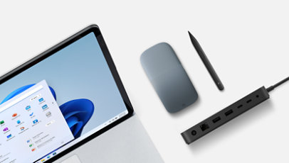 A Surface Laptop Studio with a Surface Slim Pen 2, a Thunderbolt 4 Dock, and an ice blue Arc Mouse.