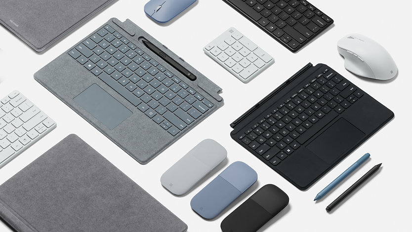 Různé příslušenství Surface, jako je klávesnice, myš a tenké pero.