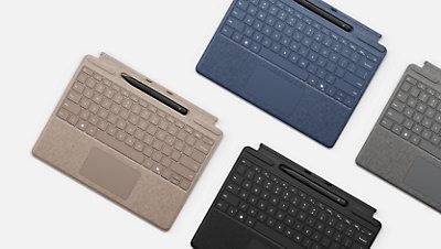 Surface Pro Keyboard with Surface Slim Pen 2 in the pen storage tray in Dune, Sapphire, Platinum and Black. 