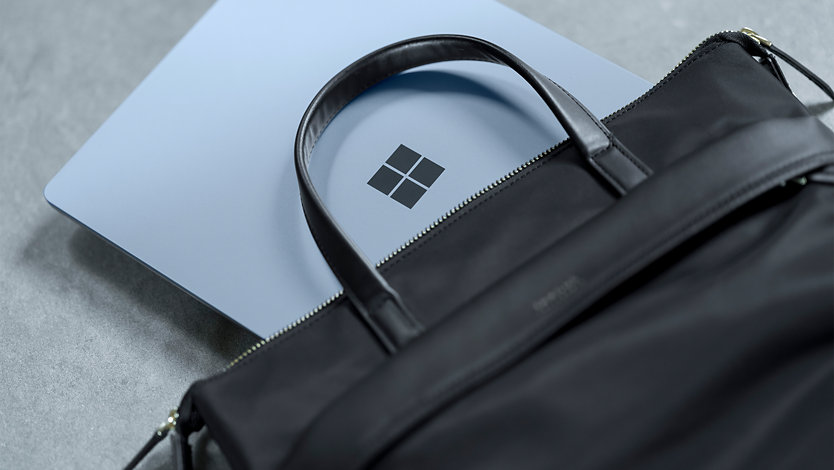 A Surface for Business device in a leather laptop bag.