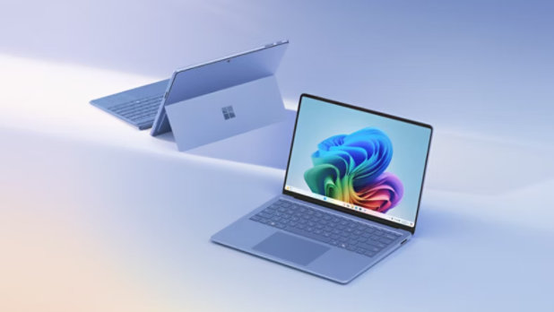 A sapphire Surface Pro in kickstand mode, facing away, and a sapphire Surface Laptop facing forward.