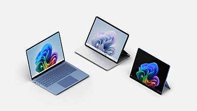 A Sapphire blue Surface Laptop Copilot plus PC, a Surface Laptop Studio 2, and a black Surface Pro Copilot plus PC. 