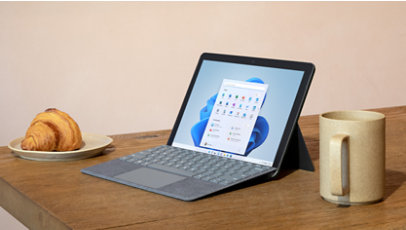 A laptop and coffee mug on a desk