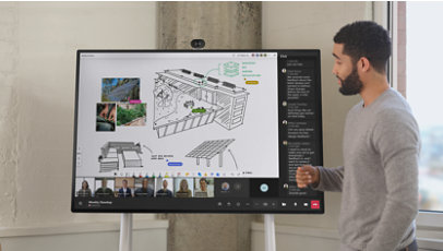 A man uses a Surface Hub 3 to collaborate with his coworkers on Teams.