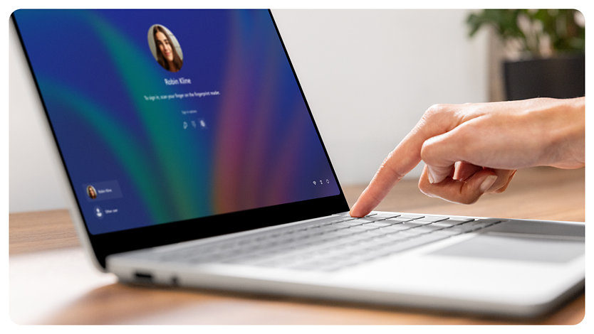 A person uses the Fingerprint Power Button to sign in to a Surface Laptop for Business.