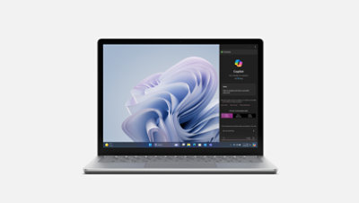 A front view of Surface Laptop 6 for Business in platinum with Copilot menu on screen.