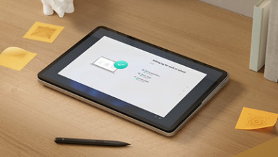 A Surface Laptop Studio 2 for Business in Studio Mode rests beside a Surface Slim Pen for Business. 