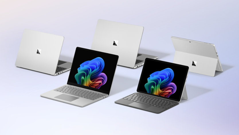 A variety of Surface devices in a group together, some facing forward, others facing away, all in Platinum.