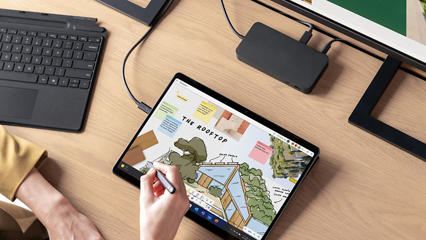 An architect draws on a Surface Pro 10 with a Surface slim pen.