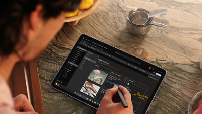 An adult male inking on the Violet Surface Pro 12 in the OneNote app. 