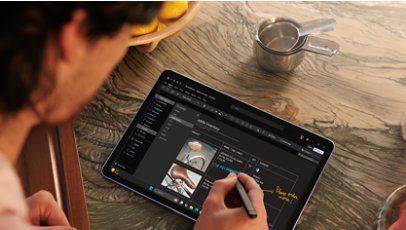 An adult male inking on the Violet Surface Pro 12 in the OneNote app.