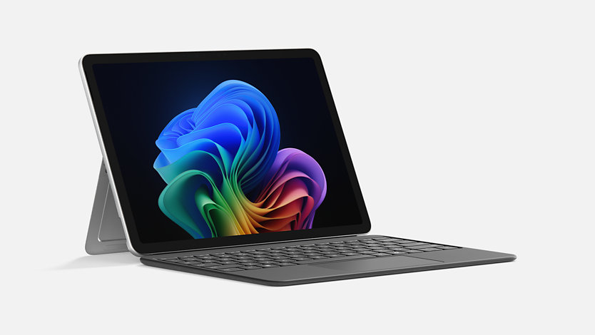 A Surface Pro in laptop mode with the kickstand engaged and connected to a Surface Pro 12-inch Keyboard. 