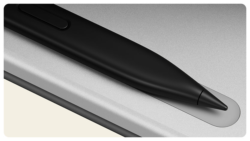 A Surface Slim Pen rests in the pen tray of a Surface Pro in the color Platinum. 