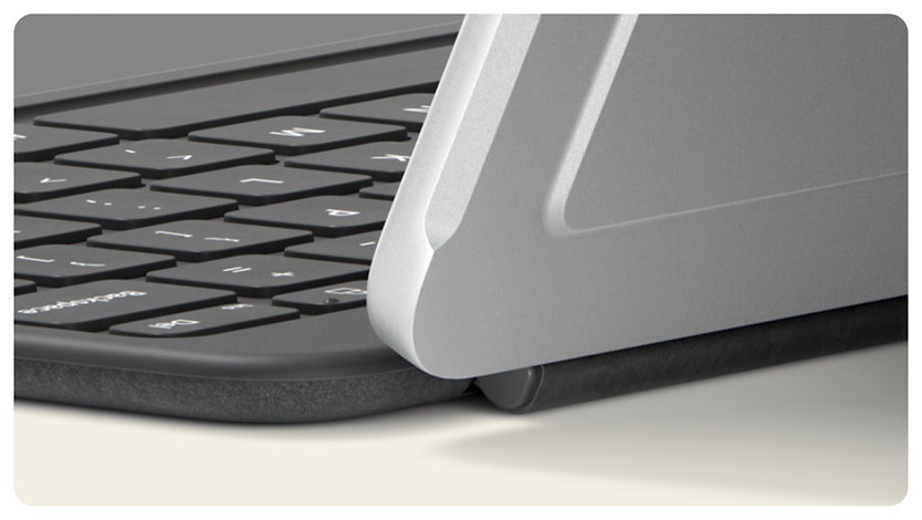 A close-up of a Slate Surface Pro 12-inch Keyboard’s hinge connected to a Platinum Surface Pro.