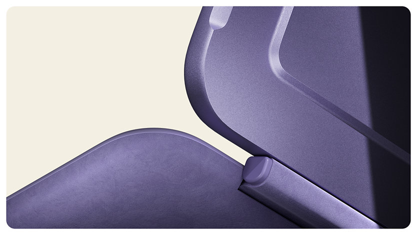 A close-up of a Violet Surface Pro 12-inch Keyboard’s hinge connected to a Violet Surface Pro. 