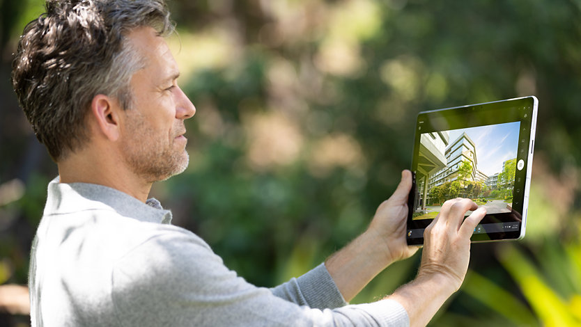 A person uses Surface Pro 9 with 5G for Business to take photos while on a job site.