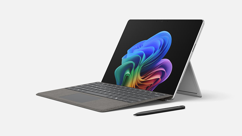 The Surface Pro for Business in laptop mode while connected to a Surface Pro Keyboard with a Surface Slim Pen sitting to the side.