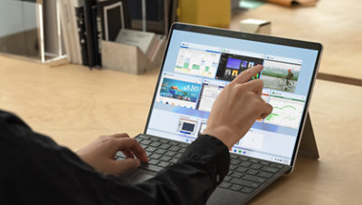 A person using a Surface Pro X. 
