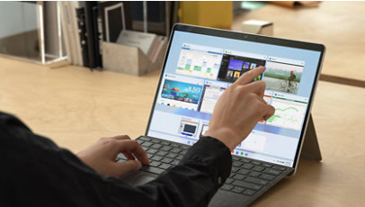 A person using a Surface Pro X. 