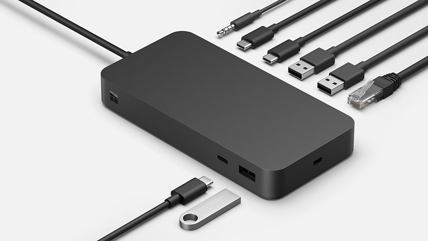 The various ports of Surface Thunderbolt™ 4 Dock surrounded by various connective cables.