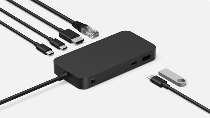A Surface USB4 Dock for Business surrounded by various connective cables.