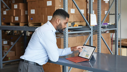 A warehouse associate uses Microsoft 365 on a 2-in-1 device. 